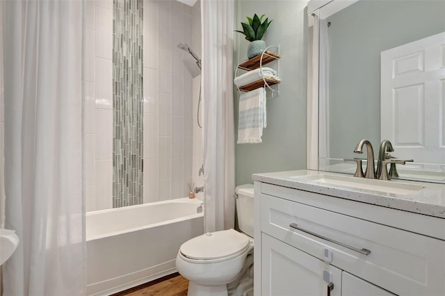 full bathroom featuring wood-type flooring, toilet, vanity, and shower / tub combo