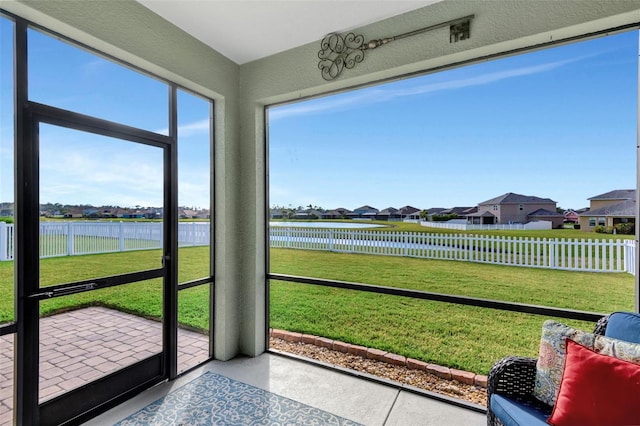 sunroom / solarium with a water view