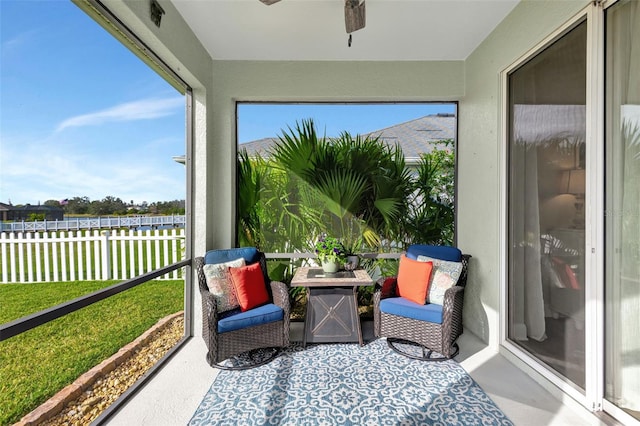 sunroom featuring ceiling fan