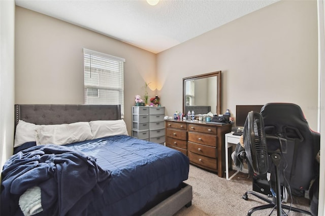 bedroom with light carpet and a textured ceiling