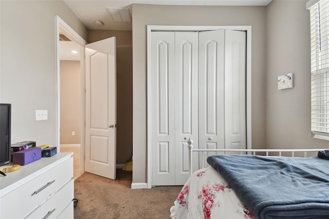 carpeted bedroom featuring a closet