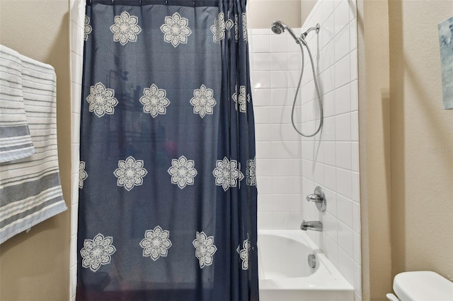 bathroom featuring toilet and shower / tub combo with curtain