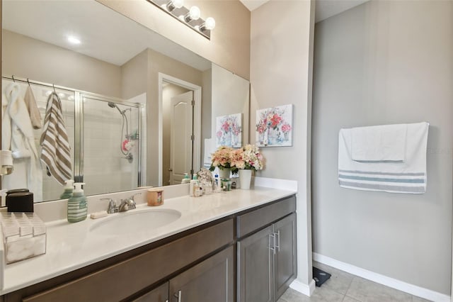 bathroom featuring a shower with shower door, vanity, and tile patterned flooring