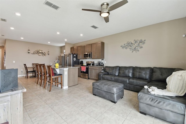 tiled living room with ceiling fan