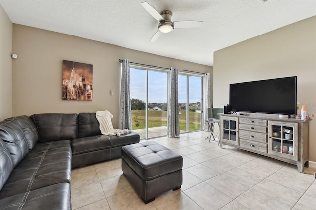 tiled living room with a textured ceiling and ceiling fan