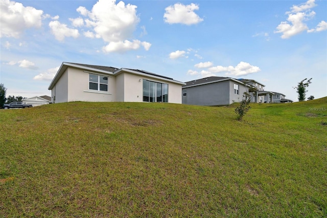 rear view of property with a lawn