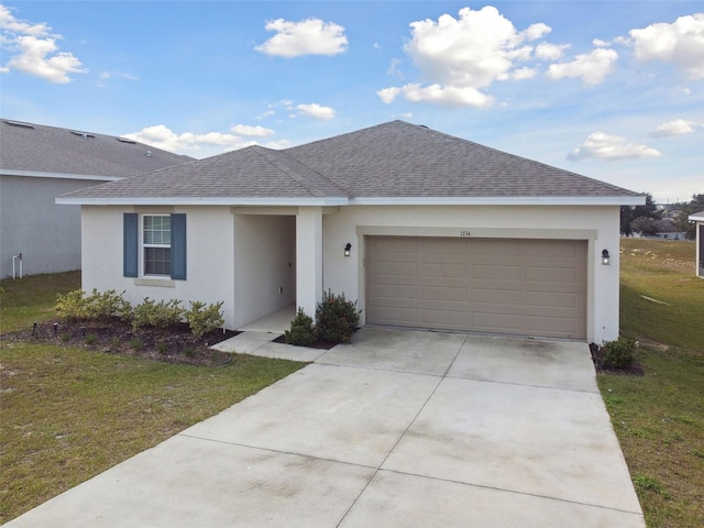 single story home featuring a front lawn and a garage