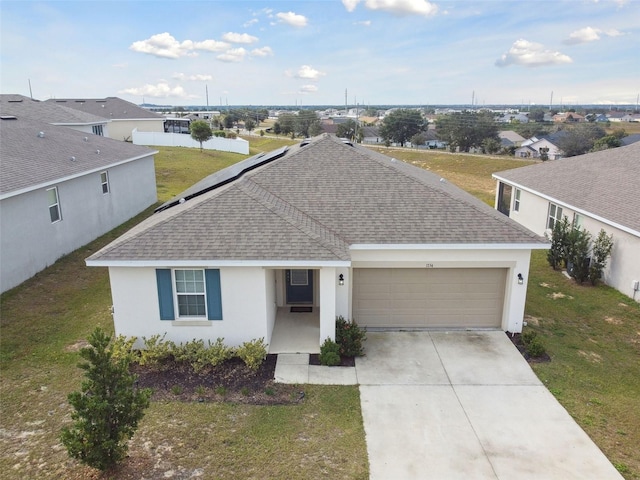 single story home featuring a front lawn and a garage