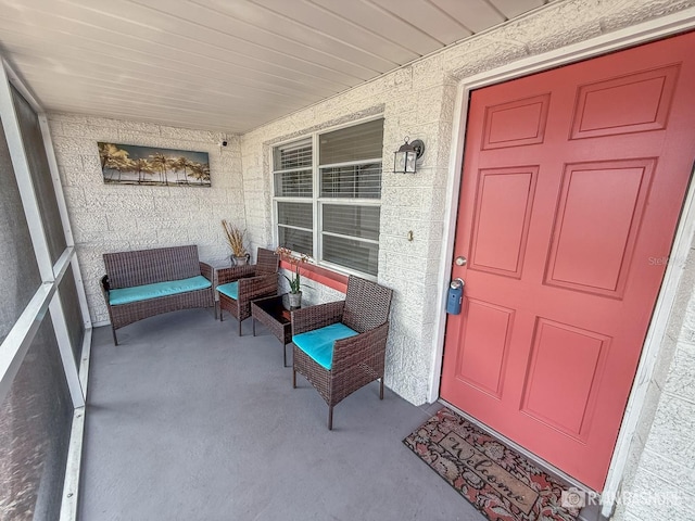 view of exterior entry with a porch