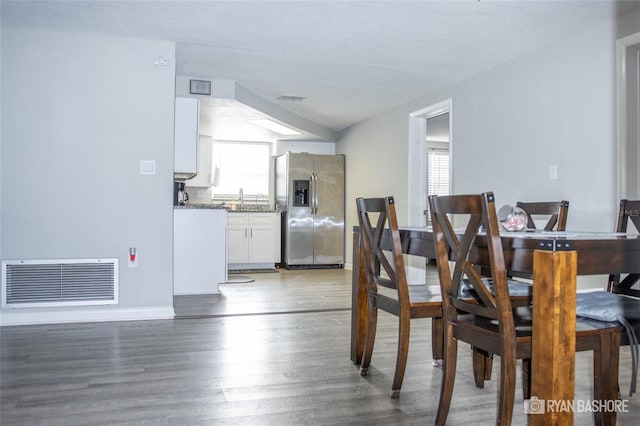 dining area with sink, dark hardwood / wood-style floors, and a wealth of natural light