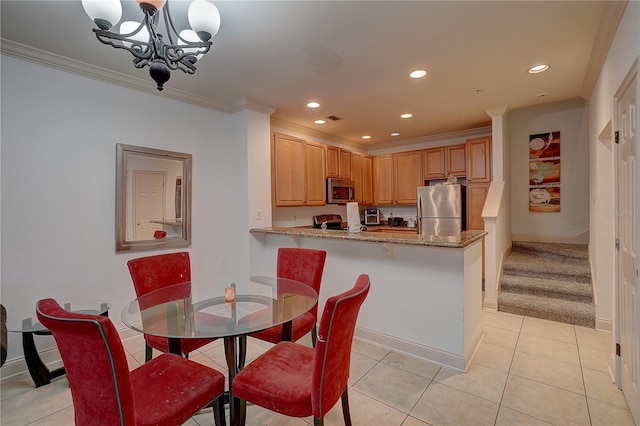 dining area with light tile patterned floors, crown molding, and a notable chandelier