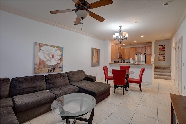 living room featuring light tile patterned floors, ceiling fan with notable chandelier, and crown molding