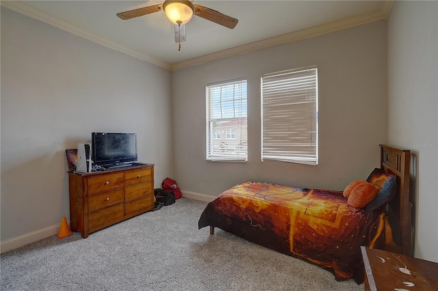 carpeted bedroom featuring ceiling fan and ornamental molding