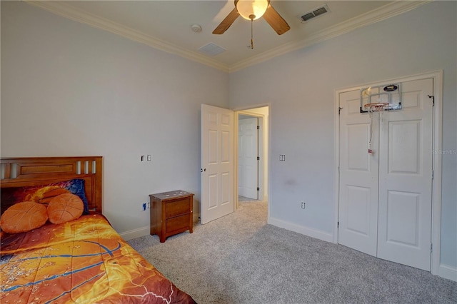 carpeted bedroom featuring ceiling fan and crown molding