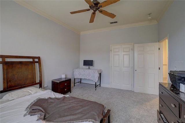 bedroom featuring ceiling fan, light carpet, a closet, and crown molding