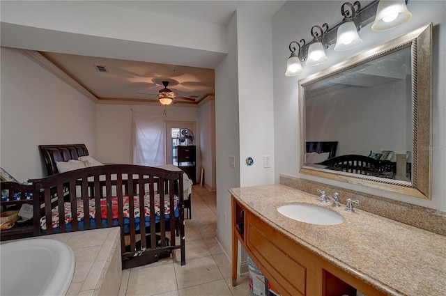 bathroom featuring tile patterned flooring, vanity, ornamental molding, ceiling fan, and a relaxing tiled tub