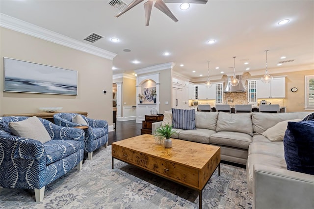 living room with ceiling fan, ornamental molding, and hardwood / wood-style flooring