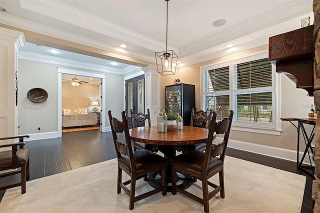 dining space featuring hardwood / wood-style flooring, decorative columns, crown molding, and ceiling fan