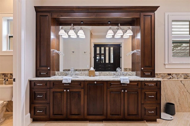 bathroom with toilet and vanity