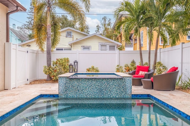 view of swimming pool featuring a patio area and a hot tub