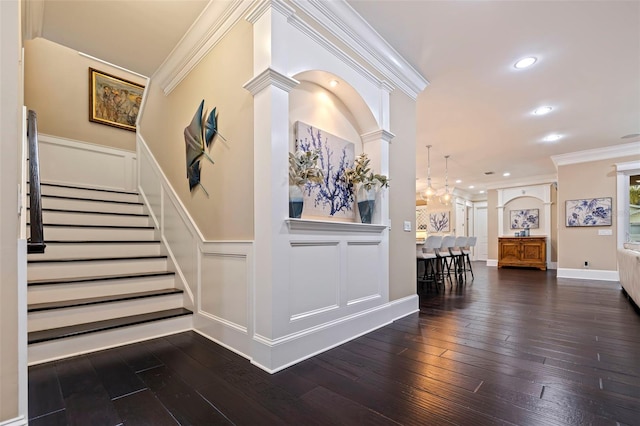 310 8th Ave N, Saint Petersburg, FL 33701 - entrance foyer featuring ornamental molding, wainscoting, dark wood-style flooring, stairway, and a decorative wall