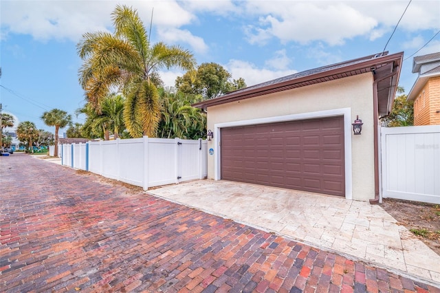 310 8th Ave N, Saint Petersburg, FL 33701 - garage with a gate, fence, and driveway