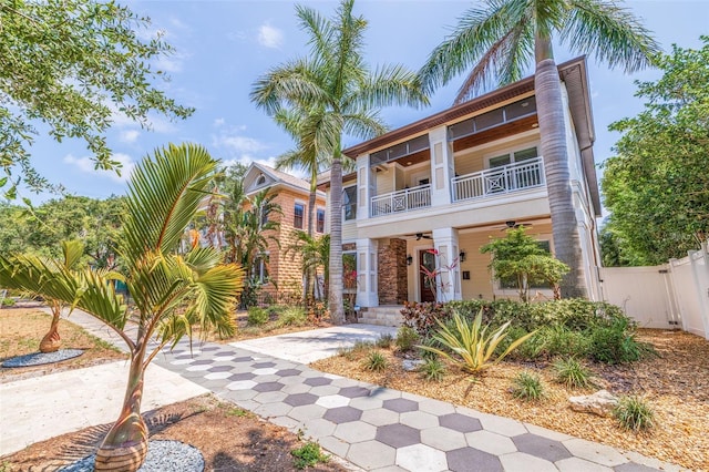 310 8th Ave N, Saint Petersburg, FL 33701 - view of front of home featuring a balcony, a ceiling fan, a gate, and fence