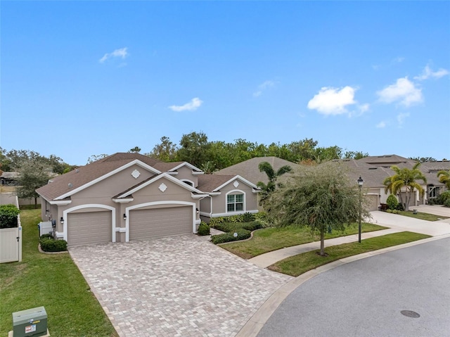 ranch-style home featuring a front yard and a garage