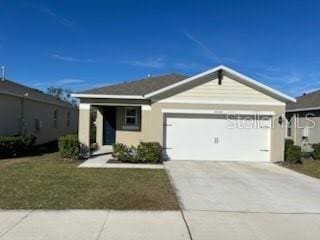 view of front of property with a front lawn and a garage