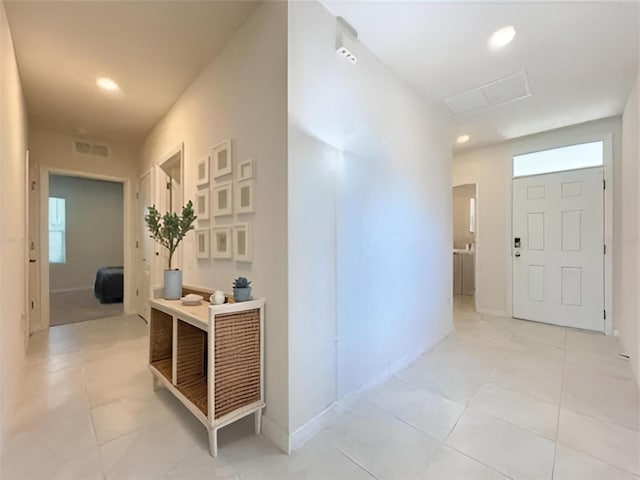 hall with light tile patterned floors