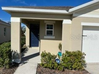 view of exterior entry featuring a garage