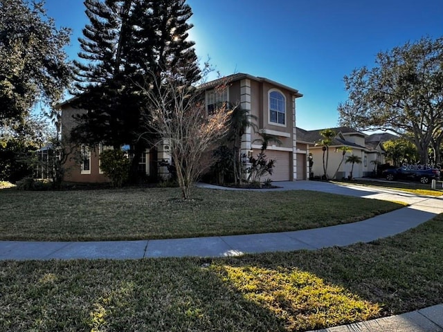 front of property featuring a garage and a front lawn