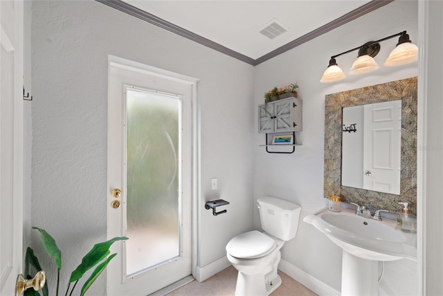 bathroom featuring tile patterned flooring, a healthy amount of sunlight, ornamental molding, and toilet