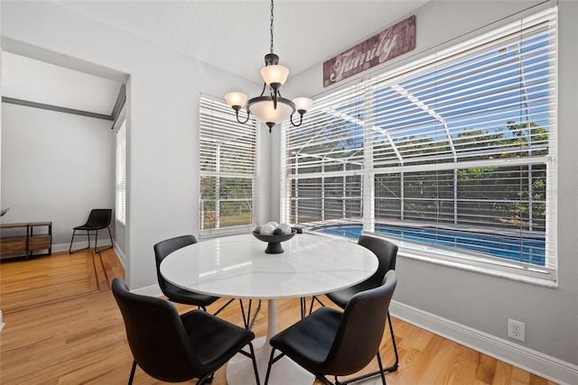 dining area featuring light hardwood / wood-style floors and a notable chandelier