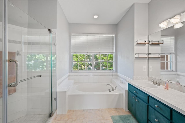 bathroom with vanity, tile patterned floors, and plus walk in shower