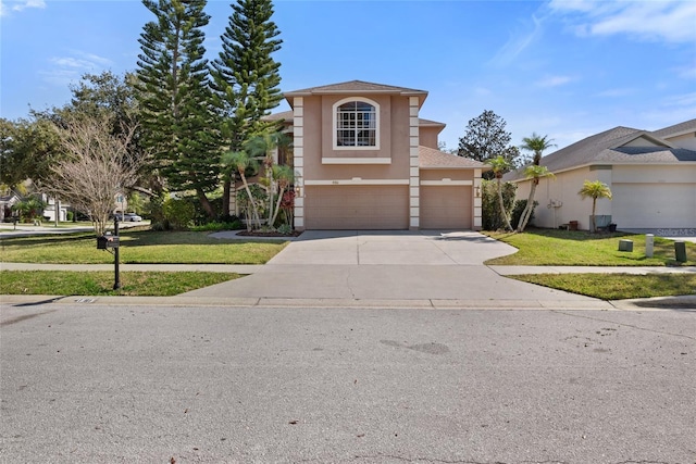 front of property featuring a garage and a front lawn