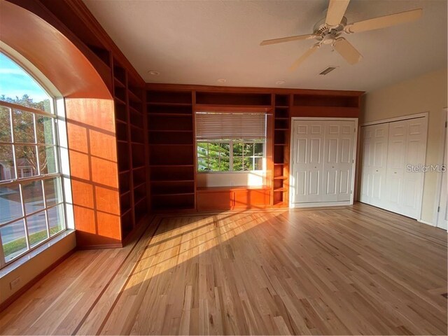 interior space with wood-type flooring and two closets