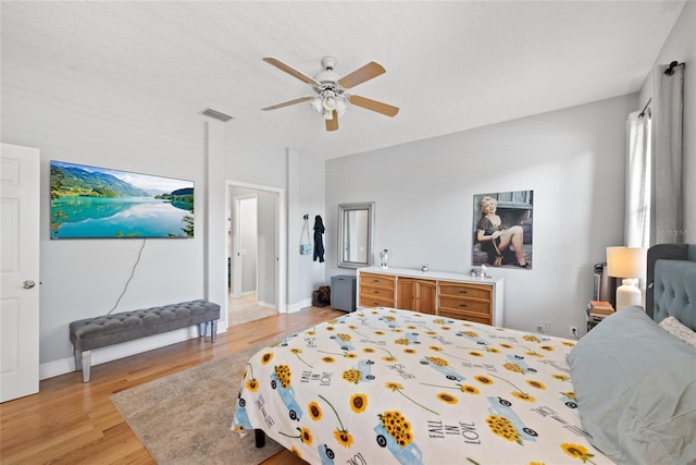 bedroom with ceiling fan and light wood-type flooring