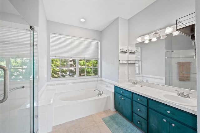 bathroom featuring tile patterned flooring, vanity, and shower with separate bathtub