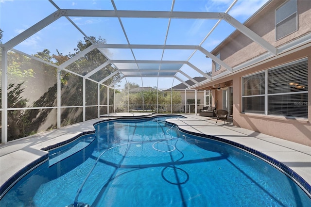 view of pool with a lanai, a patio, and ceiling fan