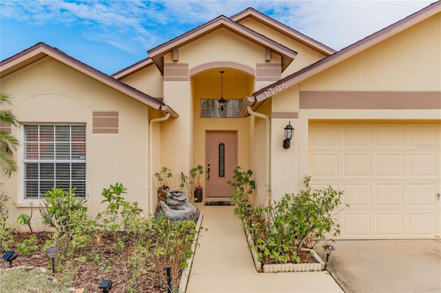 view of exterior entry with a garage