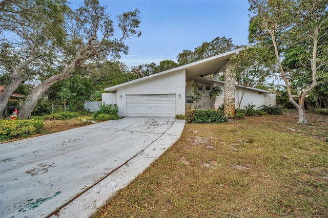 ranch-style house with a front lawn and a garage