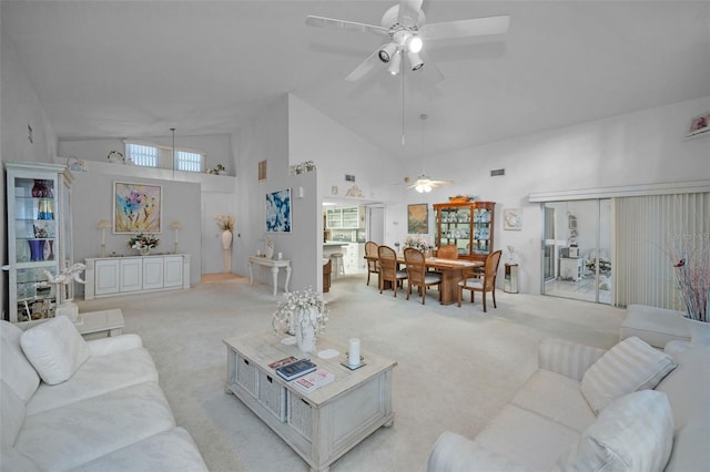 carpeted living room with high vaulted ceiling and ceiling fan