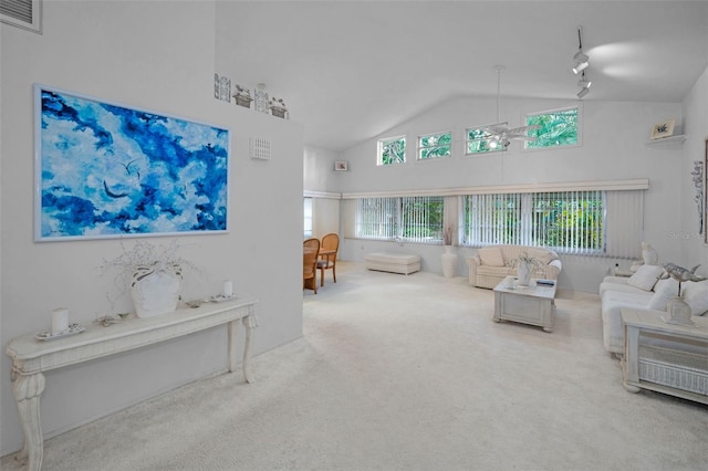 carpeted living room featuring ceiling fan and lofted ceiling