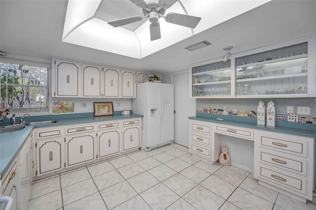 kitchen with ceiling fan, decorative backsplash, and white fridge with ice dispenser