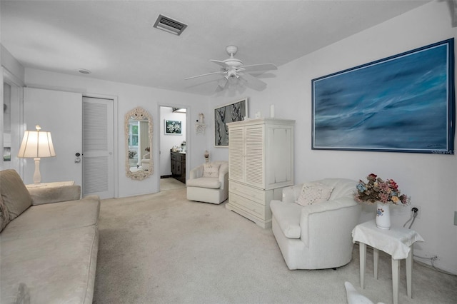 living room featuring ceiling fan and light carpet