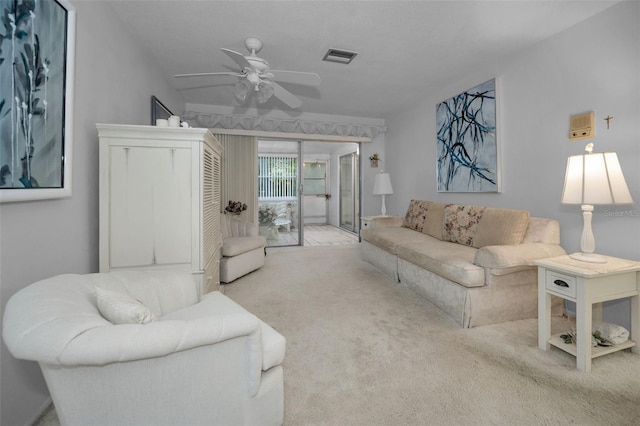 carpeted living room with ceiling fan