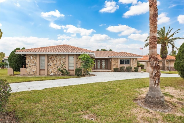 mediterranean / spanish home with a front yard