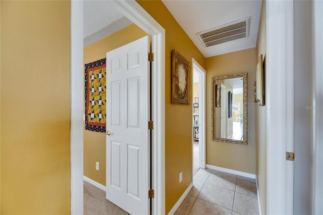 hall featuring light tile patterned floors