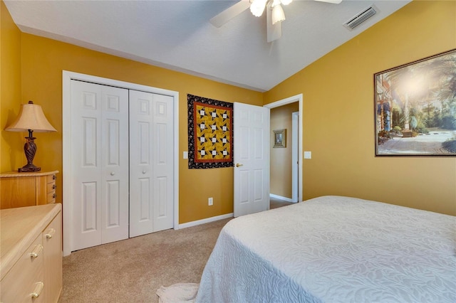 bedroom featuring ceiling fan, a closet, vaulted ceiling, and light carpet